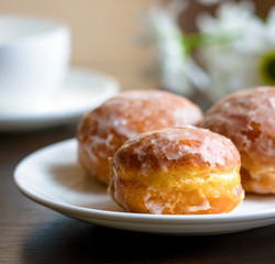 Homemade donuts on white plate with flowers