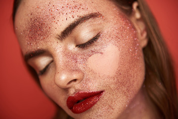 Glamorous model with glitter make up and empty heart-shaped picture on face