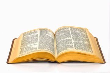 Open bible on plain white background with yellowed pages