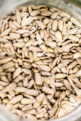 Shelled sunflower seeds in a jar on a wooden background. Healthy vegan food