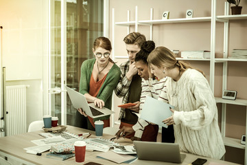 Students using laptops searching information preparing project