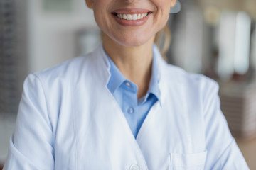 Selective focus of a pleasant female doctor smiling
