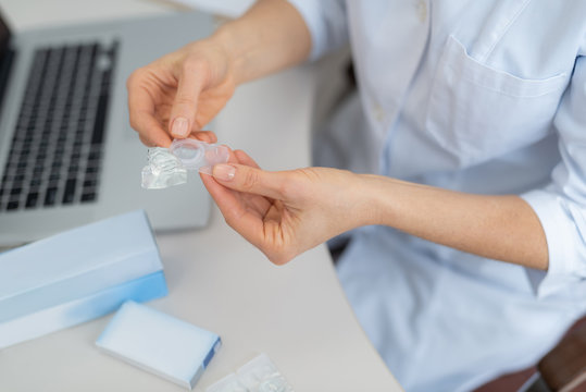 Ophthalmologist In White Lab Coat Holding Case With Contact Lens