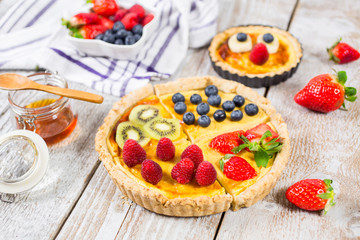 Fruit tarts with sweet fresh berries. Freshly baked cake. Decorated with a  berry. Fruit pie. - Image