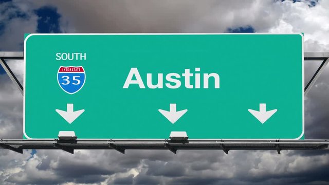 Austin Texas interstate route 35 overhead freeway directional arrow sign with time lapse clouds.