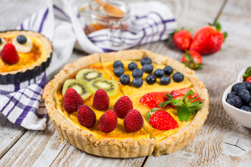 Fruit tarts with sweet fresh berries. Freshly baked cake. Decorated with a  berry. Fruit pie. - Image