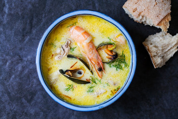 Scandinavian creamy fish soup with halibut, prawns and mussels