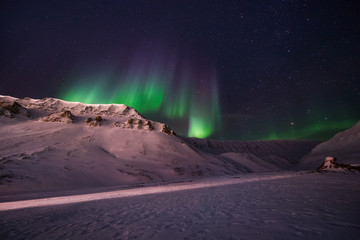 Fototapeta na wymiar The polar arctic Northern lights aurora borealis sky star in Norway travel Svalbard in Longyearbyen city the moon mountains