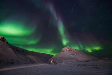 The polar arctic Northern lights aurora borealis sky star in Norway travel Svalbard in Longyearbyen city the moon mountains