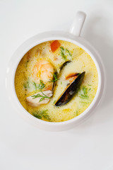 Scandinavian creamy fish soup with halibut, prawns and mussels