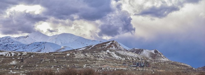 inter Panorama of Oquirrh Mountain range snow capped, which includes The Bingham Canyon Mine or Kennecott Copper Mine, rumored the largest open pit copper mine in the world in Salt Lake Valley, Utah. 