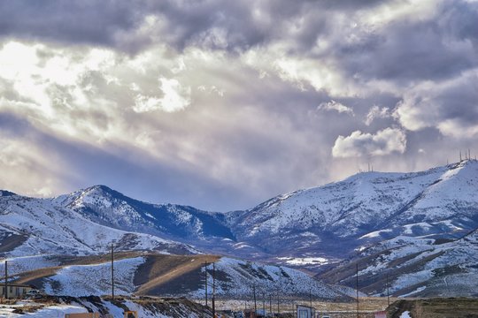 inter Panorama of Oquirrh Mountain range snow capped, which includes The Bingham Canyon Mine or Kennecott Copper Mine, rumored the largest open pit copper mine in the world in Salt Lake Valley, Utah.
