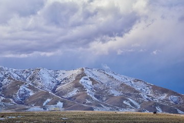 inter Panorama of Oquirrh Mountain range snow capped, which includes The Bingham Canyon Mine or Kennecott Copper Mine, rumored the largest open pit copper mine in the world in Salt Lake Valley, Utah. 