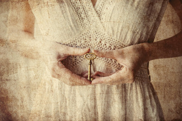 Woman holding old key in a hands