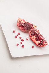 Ripe pomegranate fruits on the wooden background..