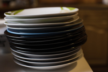 Stack of odd plates in kitchen