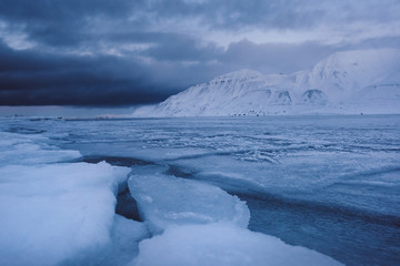 Fototapeta na wymiar norway landscape ice nature of the glacier mountains of Spitsbergen Longyearbyen Svalbard arctic ocean winter polar day blue sky