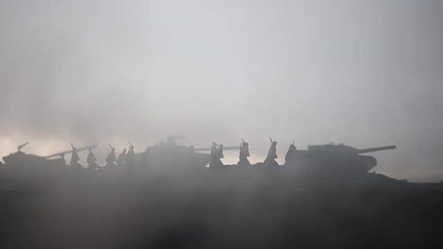 War Concept. Military silhouettes fighting scene on war fog sky background, World War Soldiers Silhouettes below Cloudy Skyline at sunset. Attack scene. Armored vehicles. tank in action