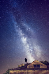 couple looking at the stars on a roof