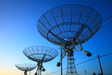 The silhouette of a radio telescope