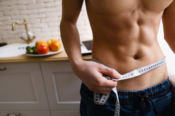 fitness, healthy lifestyle, proper nutrition, well being. athletic sporty well-formed fit man...