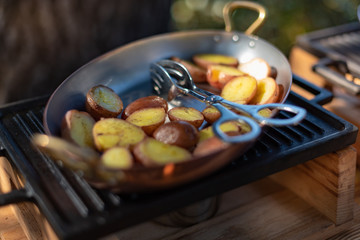 Closed up pan fried baby potato on copper pan