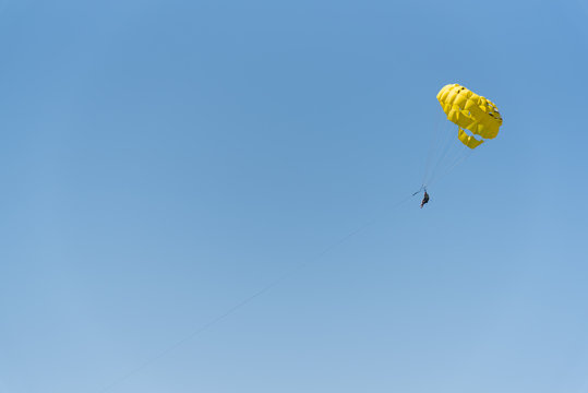 beautiful blue sky background with parachute playing