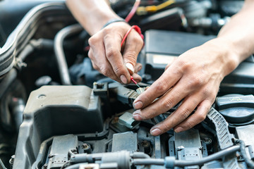 close up tool and hand of People or mechanic car repair during investigate cause of problem (electric system check) or working on automobile gasoline or diesel engine at garage