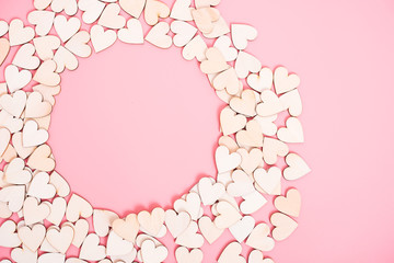 Wood hearts on pink background have sphere copy space,