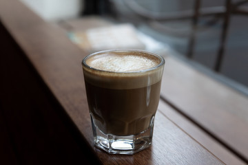 Cortado Coffee in Glass on Wooden Bar