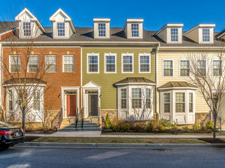 Typical American town house, town home neighborhood with colorful real estate houses at a new...