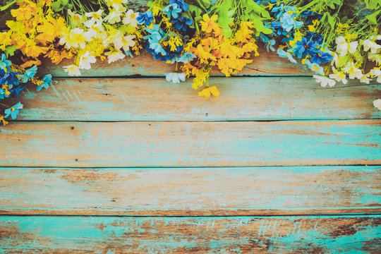 flowers blossom on vintage wooden background, border frame design. vintage color tone - concept flower of spring or summer background