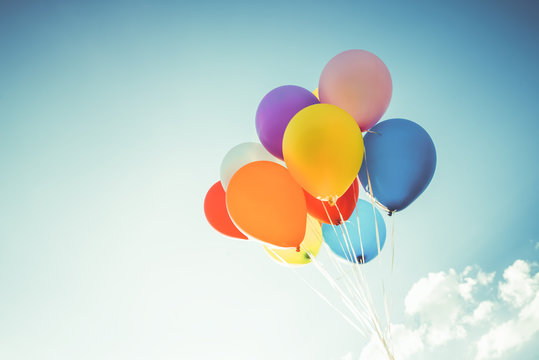Fototapeta Colorful balloons done with a retro instagram filter effect. Concept of happy birth day in summer and wedding, honeymoon party use for background. Vintage color tone style