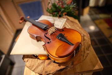 A violin lies on a small table