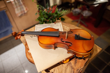 A violin lies on a small table