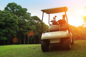 Golfcar in beautiful golf course in the evening golf course with sunshine