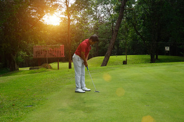 Blurred golfers are putting golf in the evening golf course golf backglound in Thailand
