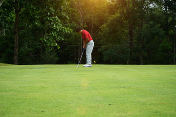 Blurred golfers are putting golf in the evening golf course golf backglound in Thailand