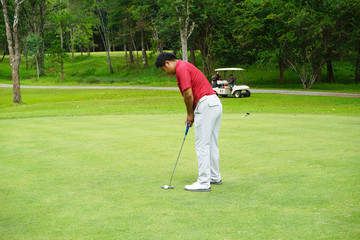 Blurred golfers are putting golf in the evening golf course golf backglound in Thailand