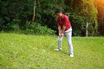 Blurred golfer playing golf in beautiful golf course in the evening golf course with sunshine in thailand