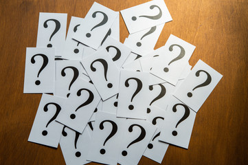 Question mark heap on table concept for confusion, question or solution