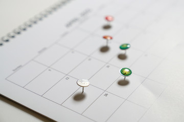 Business concept: thumbtack in calendar as reminders for meetings and appointments