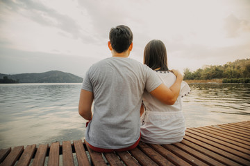 Fototapeta premium Lover couple hold together and admire the romantic beautiful lake landscape.