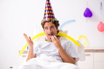 Young man celebrating his birthday in hospital