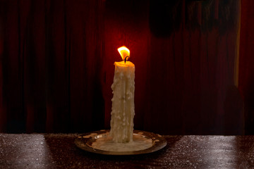 candle in the wind on a frosty winter day on a wooden table. Winter, candle on the table winter,...