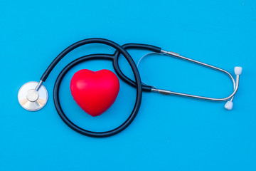 stethoscope with red heart  on blue background