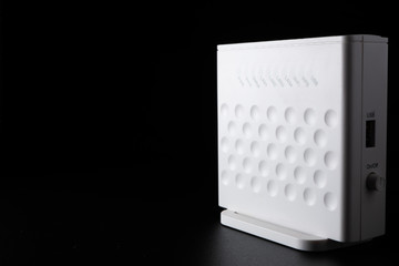 White WiFi router on black background