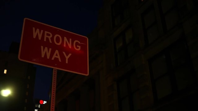 Wrong Way sign during night time in city