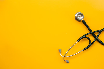Stethoscope on orange background for medical
