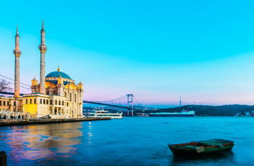 Fototapeta na wymiar Ortakoy Mosque and Bosphorus Bridge (15th July Martyrs Bridge) sunset view. Istanbul, Turkey..